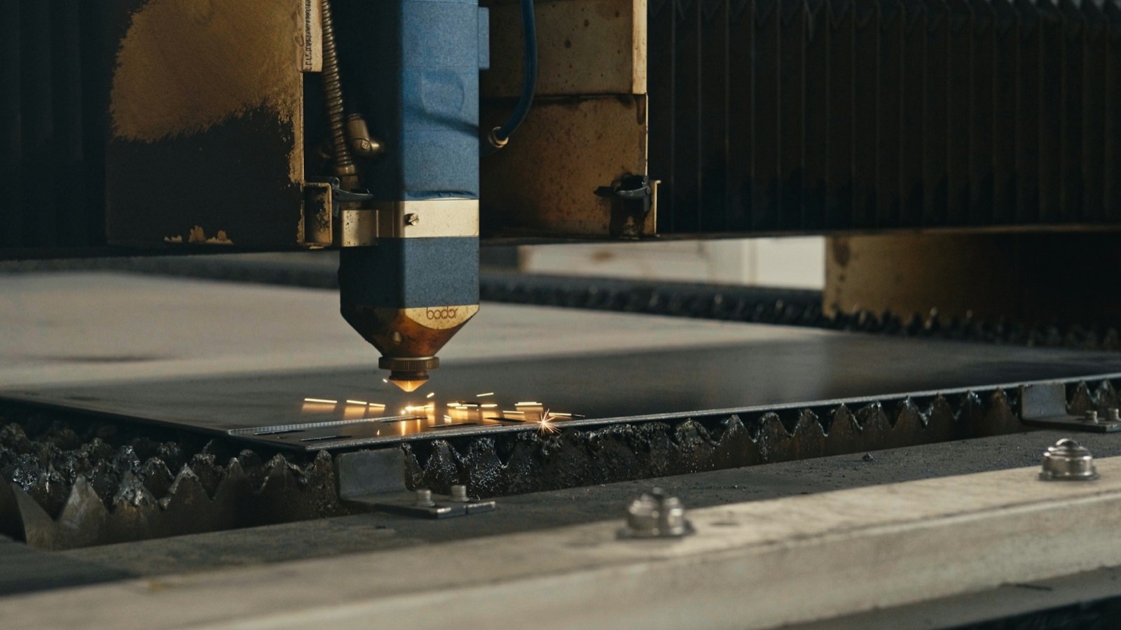 CNC cutter cutting sheet metal with sparks